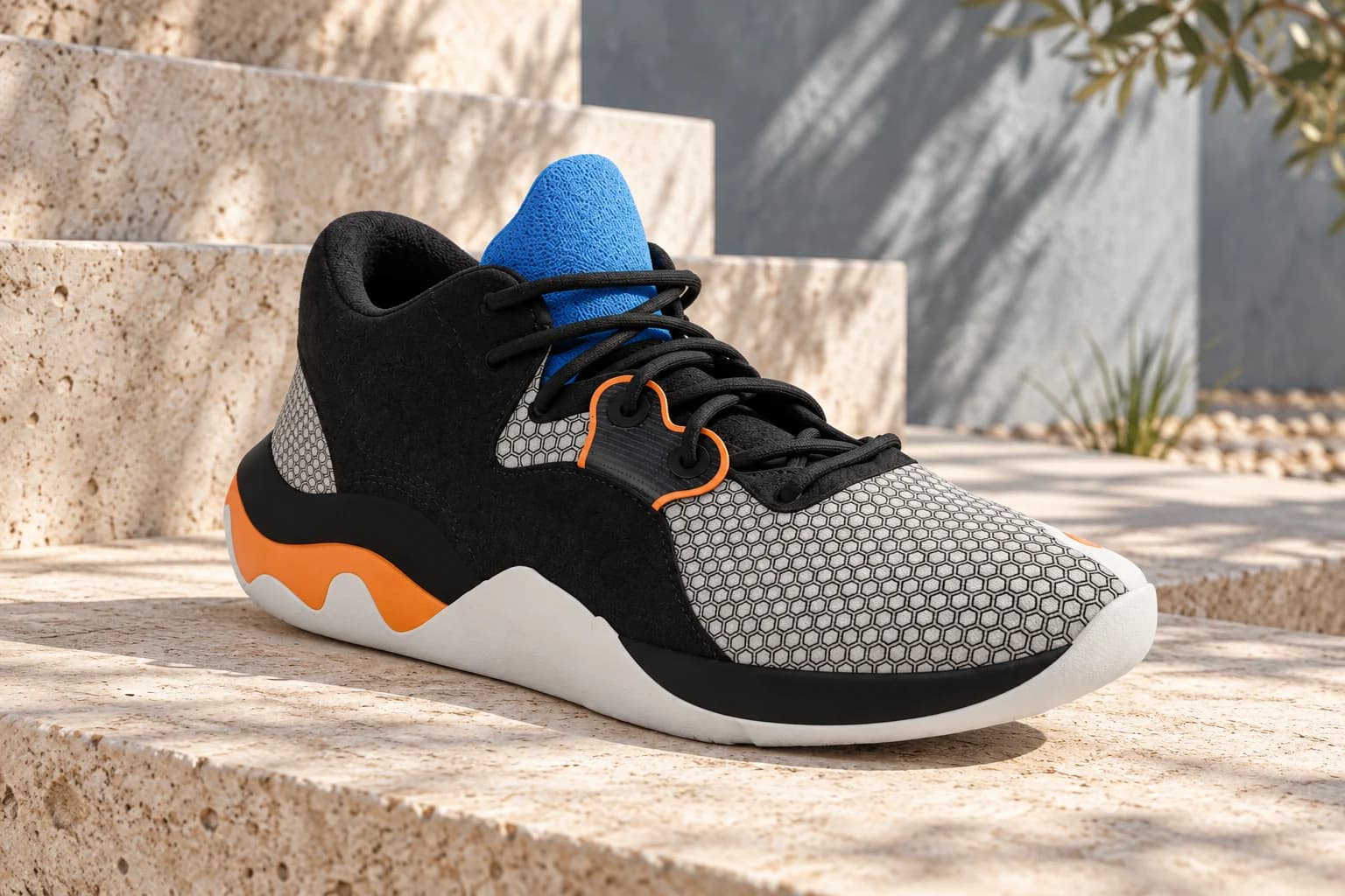 Black sneaker with a blue tongue and orange details on sunlit natural-stone steps