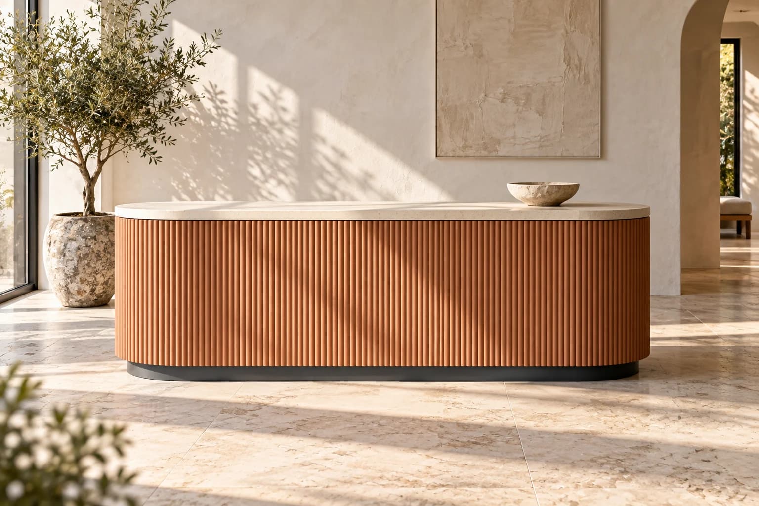 Fluted terracotta-coloured counter with a natural-stone top in raking light