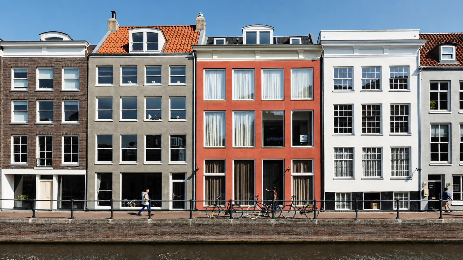 Amsterdam canal facades and bicycles beside the water