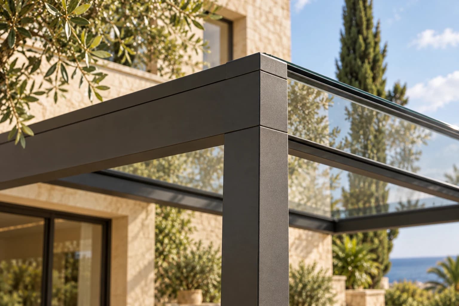 Close-up of the aluminium profiles and glass connection of a modern canopy in warm daylight.