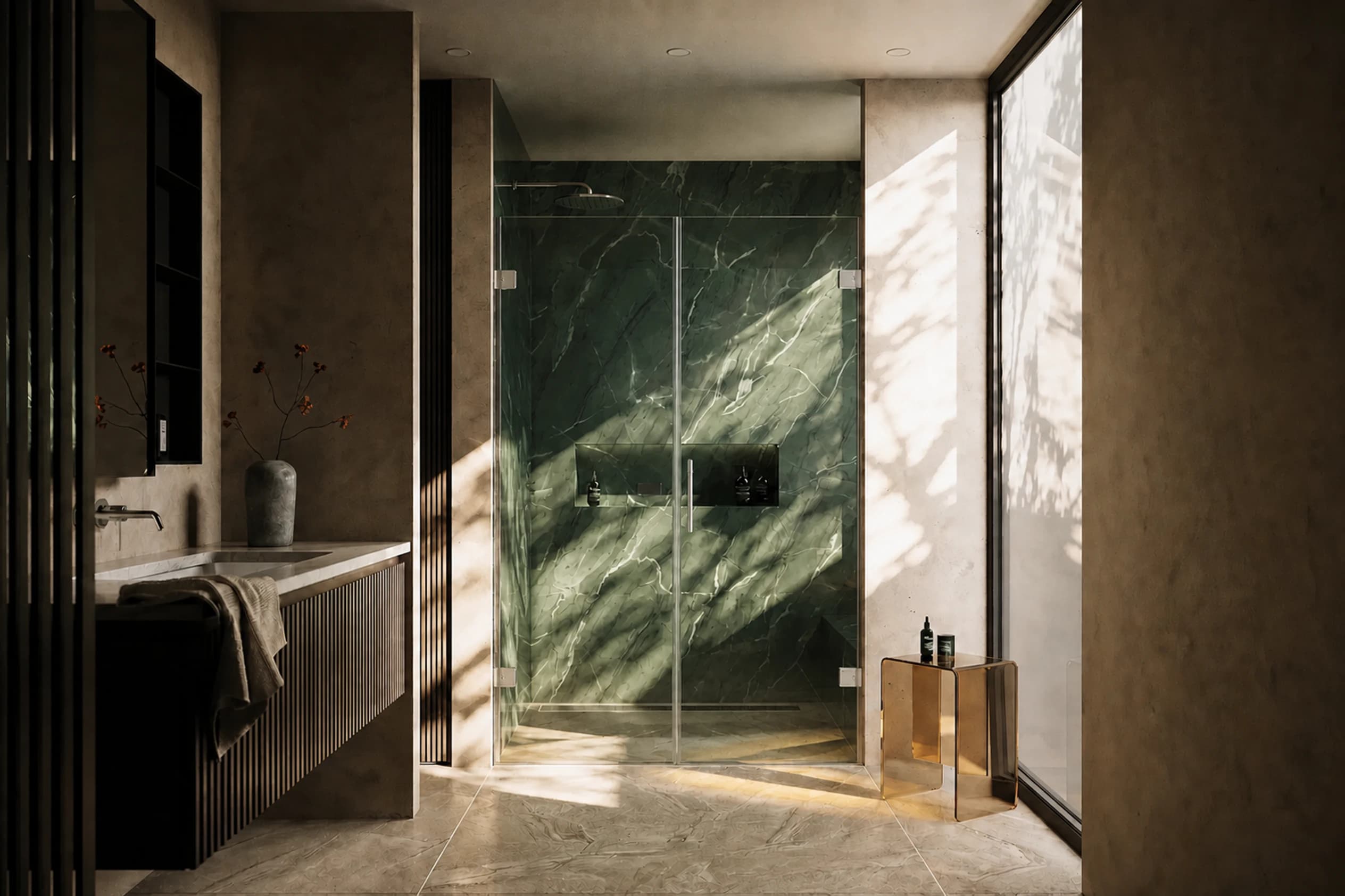 Shower glass in a bathroom with green marble