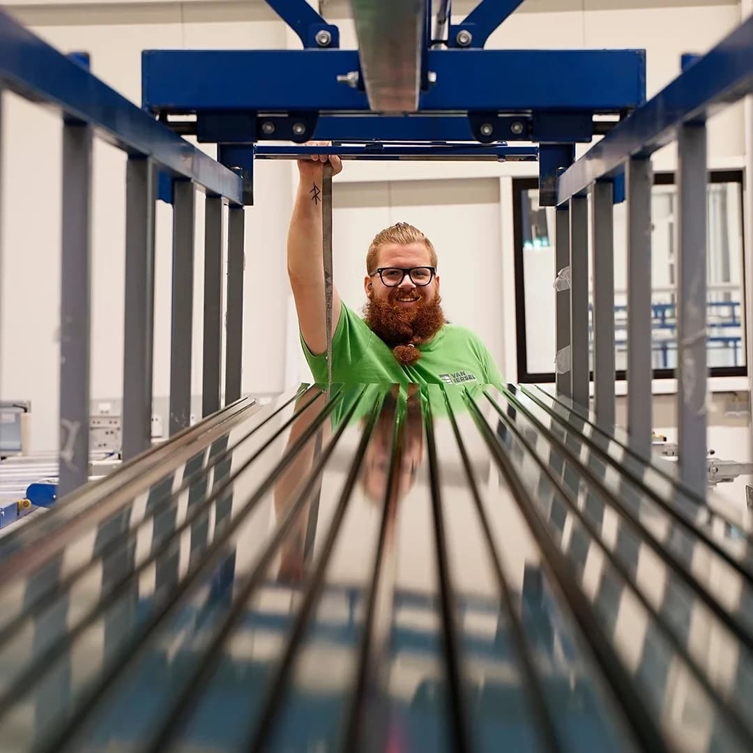 Een productiemedewerker van Van Iersel achter aluminium profielen in de werkplaats